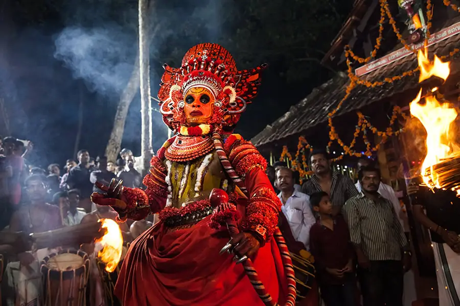 A Theyyam performer mid-ritual in Kannur, Kerala